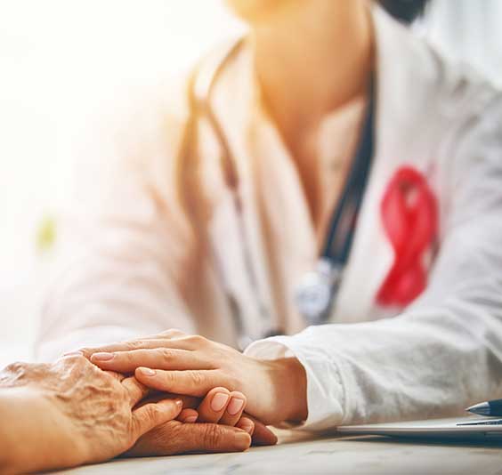 a warm female doctor holds patient's hand